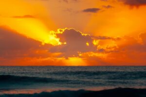 sunrise with fluffy cloud in front of the sun