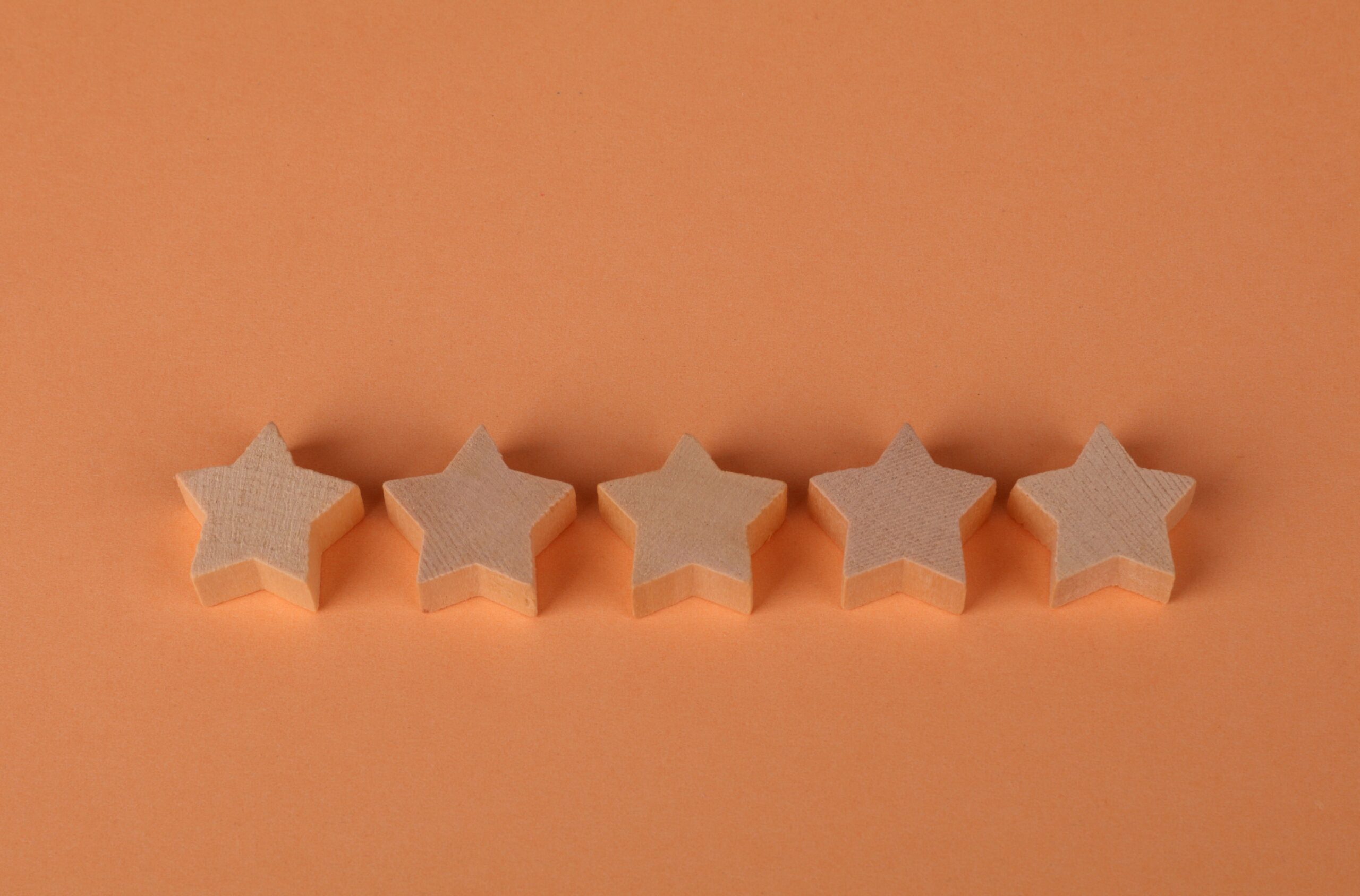 five stars on a peach colored background